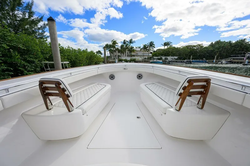 Fishability Yacht Photos Pics 2025 Valhalla Boatworks V-41 interior with white seating, wooden accents, and scenic waterfront view.