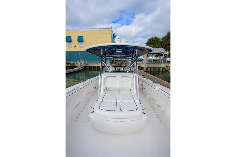 Fishability Yacht Photos Pics 2025 Valhalla Boatworks V-41, sleek white design, docked at marina under cloudy sky.