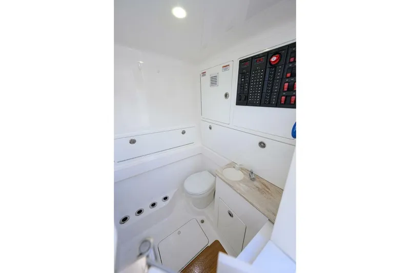 Fishability Yacht Photos Pics 2025 Valhalla Boatworks V-41 interior with control panel and compact bathroom.