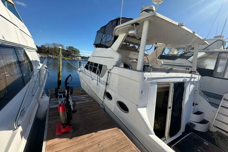  Yacht Photos Pics 1999 Silverton 442 Cockpit Motor Yacht docked at marina under clear blue sky.