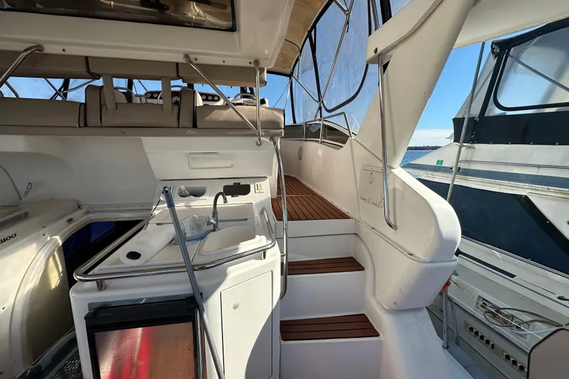  Yacht Photos Pics 1999 Silverton 442 Cockpit Motor Yacht interior with stairs and kitchenette area.