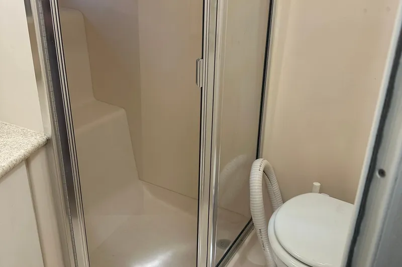  Yacht Photos Pics Bathroom interior of 1999 Silverton 442 Cockpit Motor Yacht with shower and toilet.