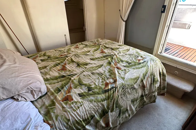  Yacht Photos Pics Cozy bedroom in 1999 Silverton 442 Cockpit Motor Yacht with tropical bedding.