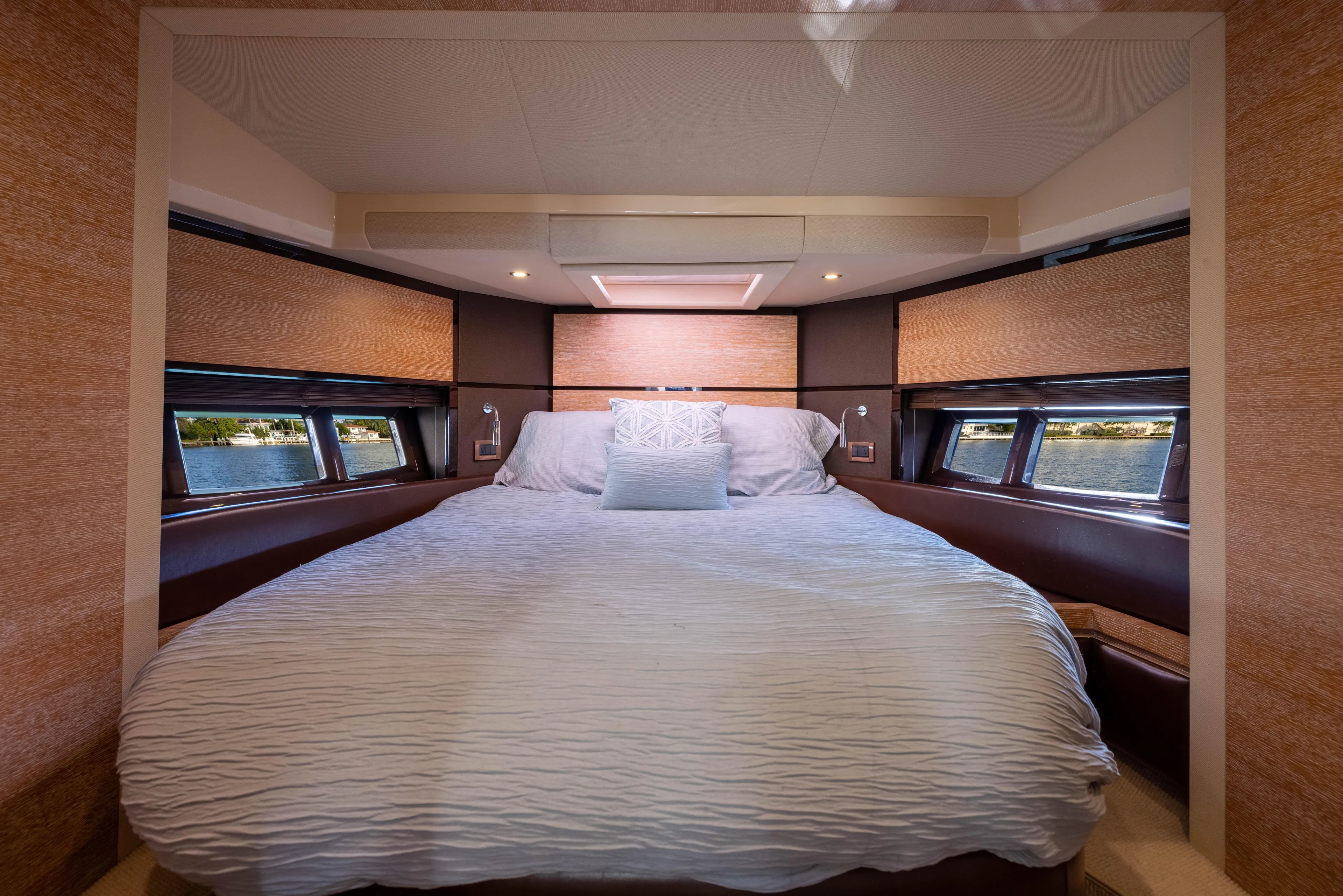 Blue Sea Yacht Photos Pics Luxurious bedroom interior of 2012 Azimut 53 yacht with elegant bedding and scenic windows.