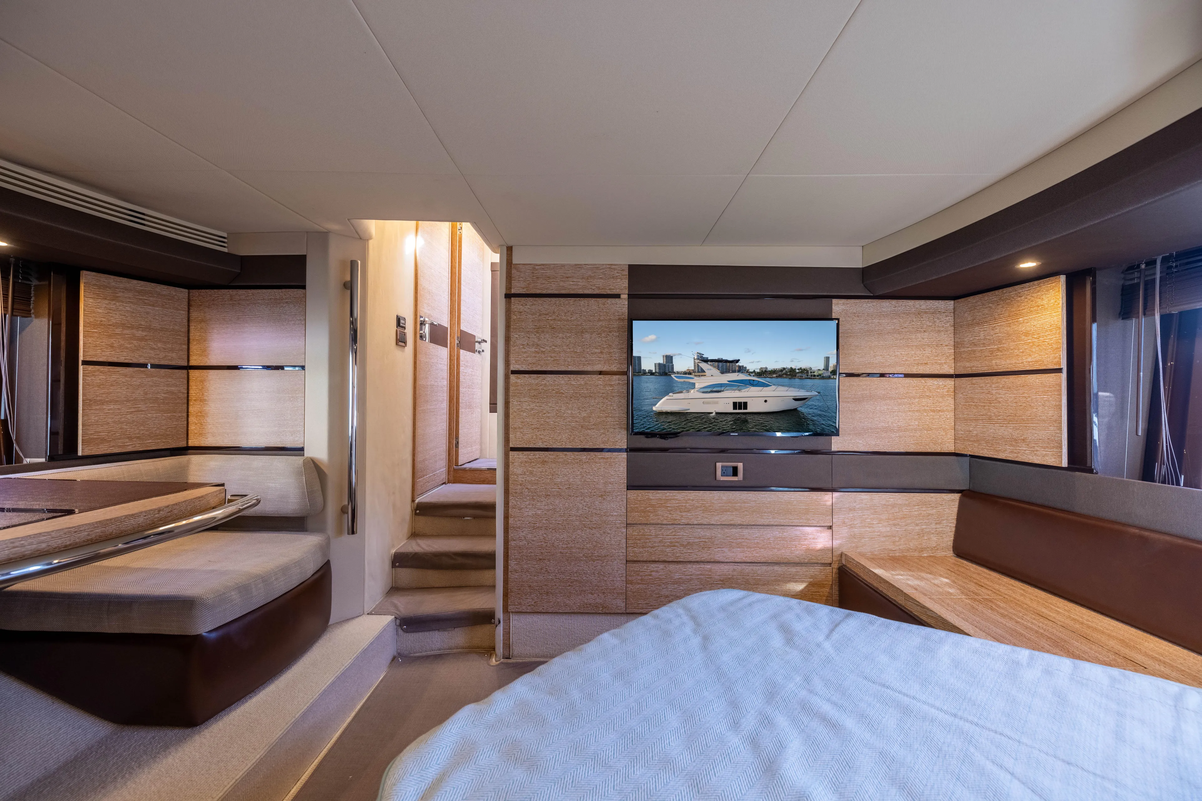 Blue Sea Yacht Photos Pics Luxurious interior of a 2012 Azimut 53 yacht with modern furnishings and a flat-screen TV.