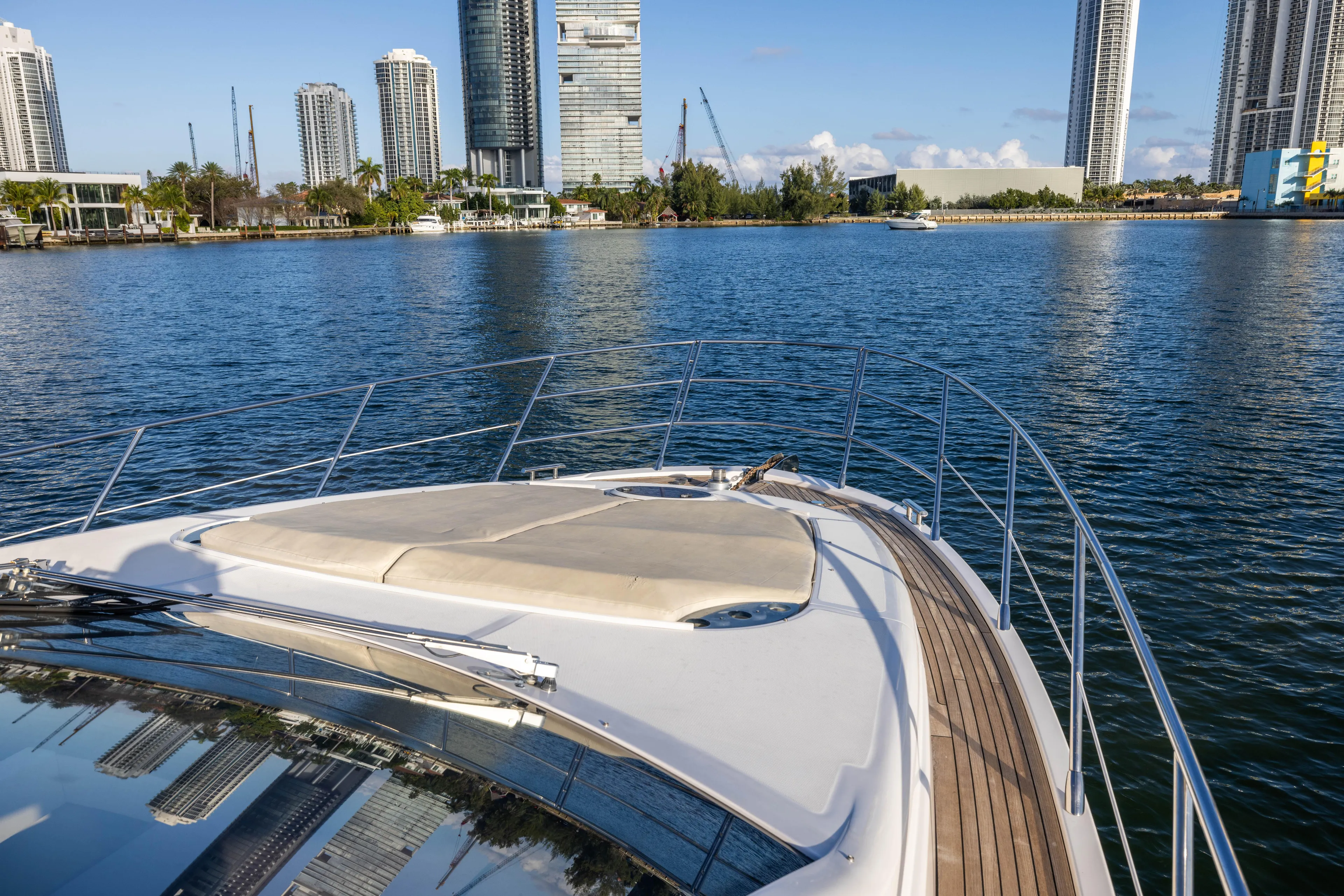 Blue Sea Yacht Photos Pics Bow view of 2012 Azimut 53 yacht cruising near city skyline.