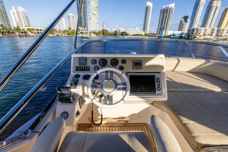Blue Sea Yacht Photos Pics Helm of 2012 Azimut 53 yacht with city skyline in background.