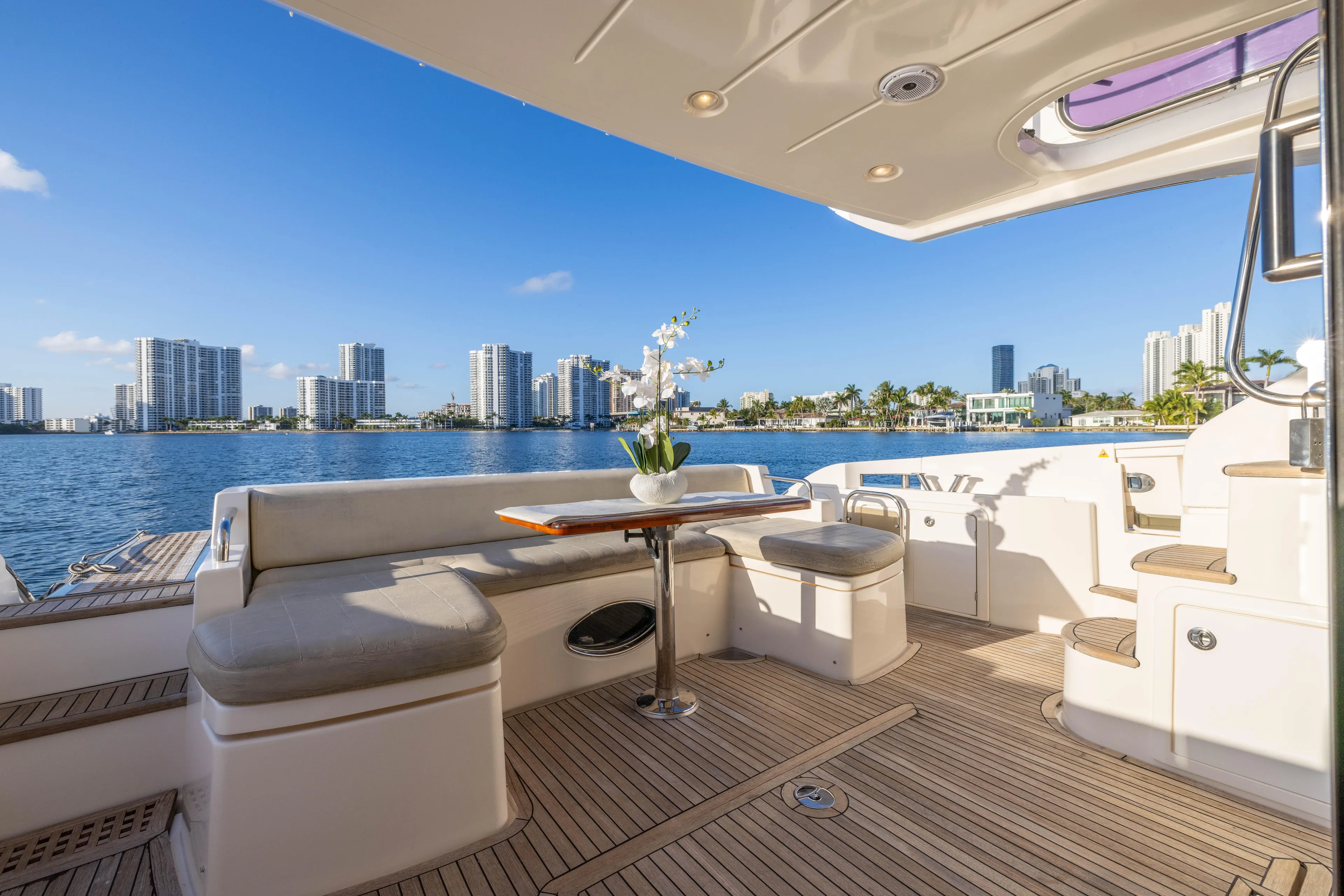 Blue Sea Yacht Photos Pics Luxurious 2012 Azimut 53 yacht deck with seating, table, and scenic waterfront view.