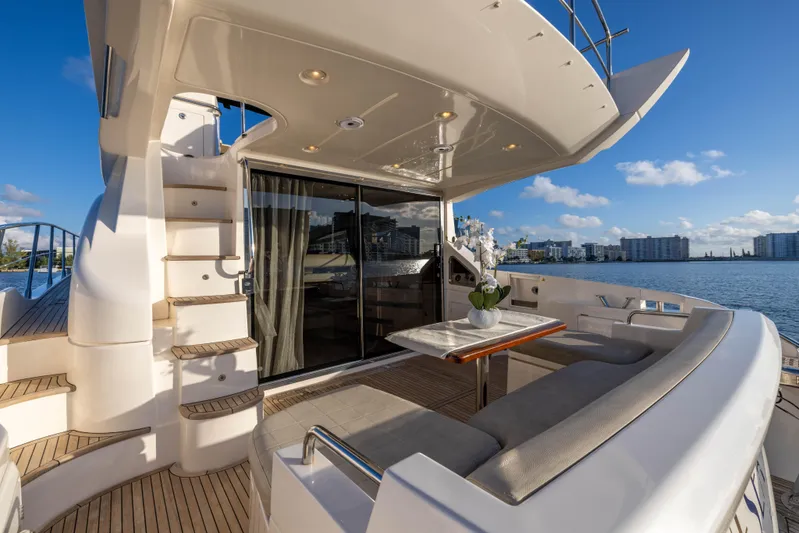 Blue Sea Yacht Photos Pics Luxurious 2012 Azimut 53 yacht deck with seating, table, and scenic waterfront view.