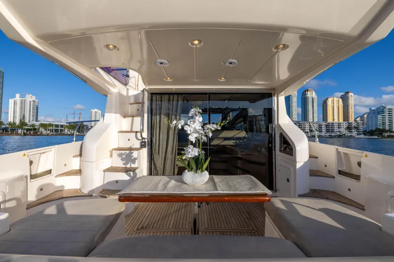 Blue Sea Yacht Photos Pics Luxurious 2012 Azimut 53 yacht deck with elegant seating and city skyline view.