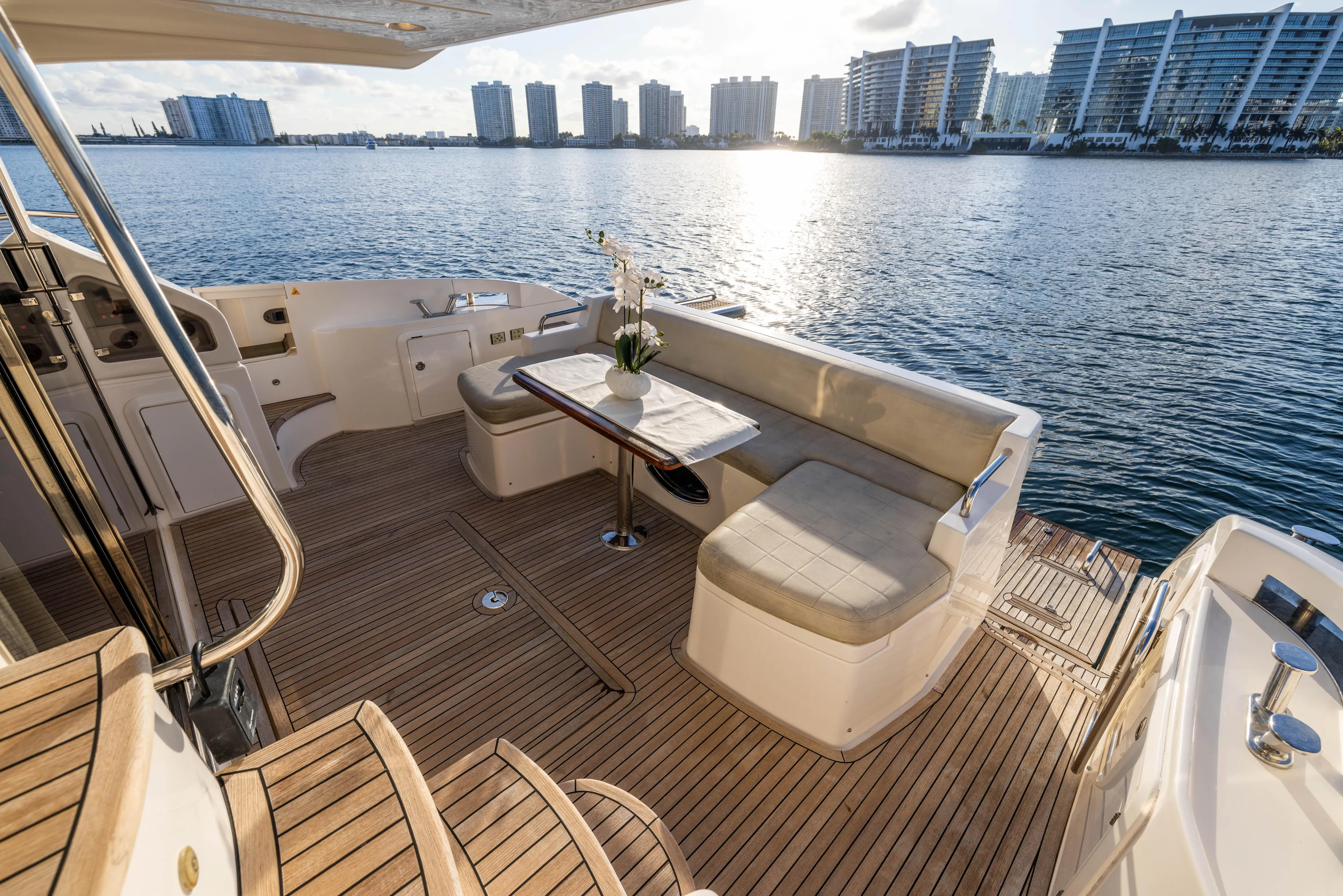 Blue Sea Yacht Photos Pics Luxurious 2012 Azimut 53 yacht deck with seating, overlooking serene waterfront cityscape.