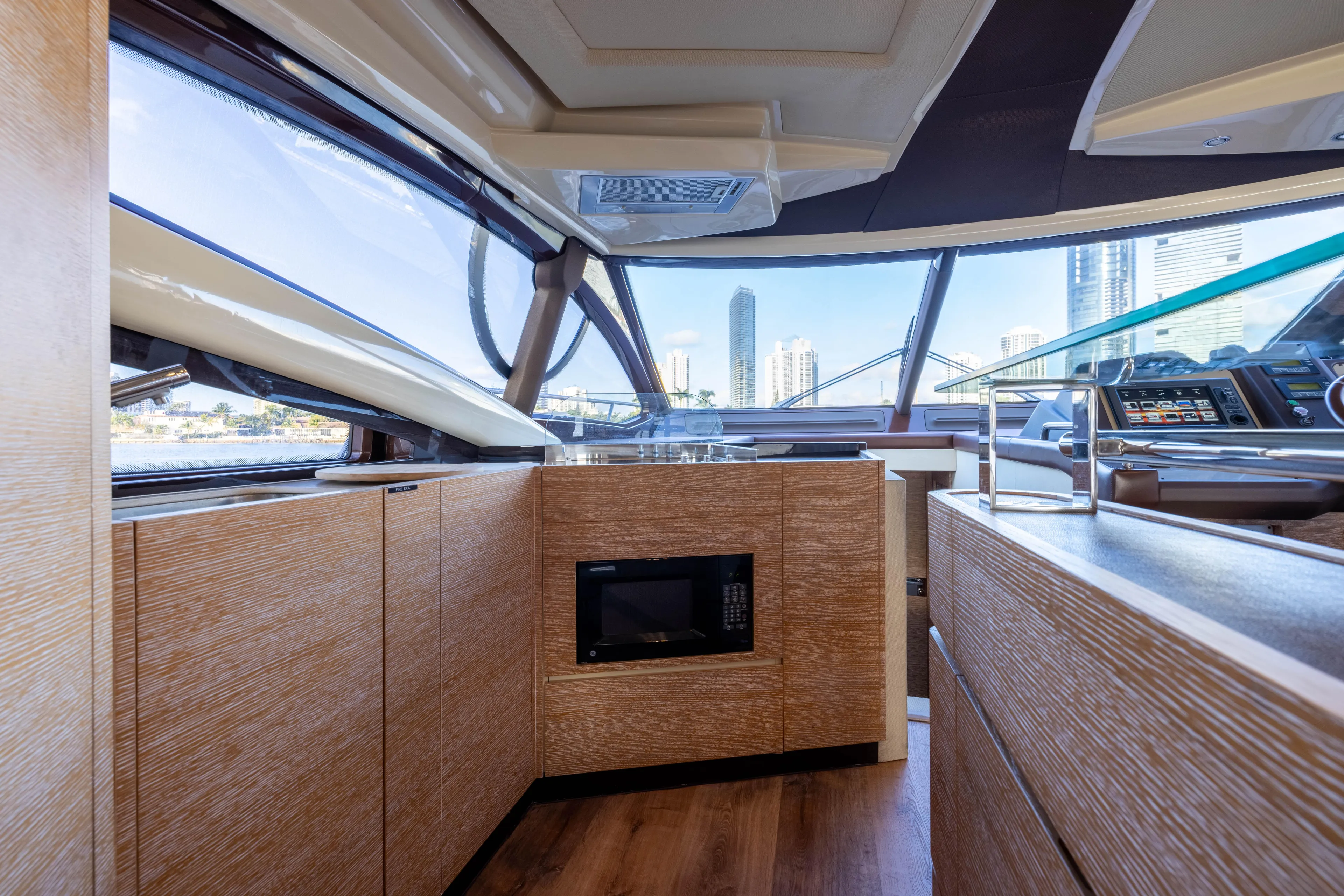 Blue Sea Yacht Photos Pics Interior of 2012 Azimut 53 yacht with modern wood cabinetry and panoramic windows.