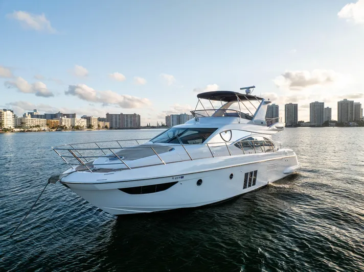 Blue Sea Yacht Photos Pics Azimut 53 yacht from 2012 on water, city skyline in background.