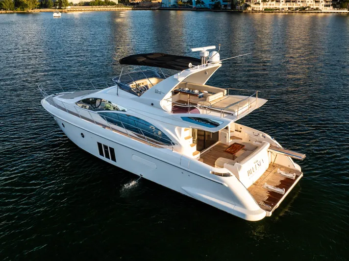 Blue Sea Yacht Photos Pics Luxurious 2012 Azimut 53 yacht cruising on serene waters at sunset.