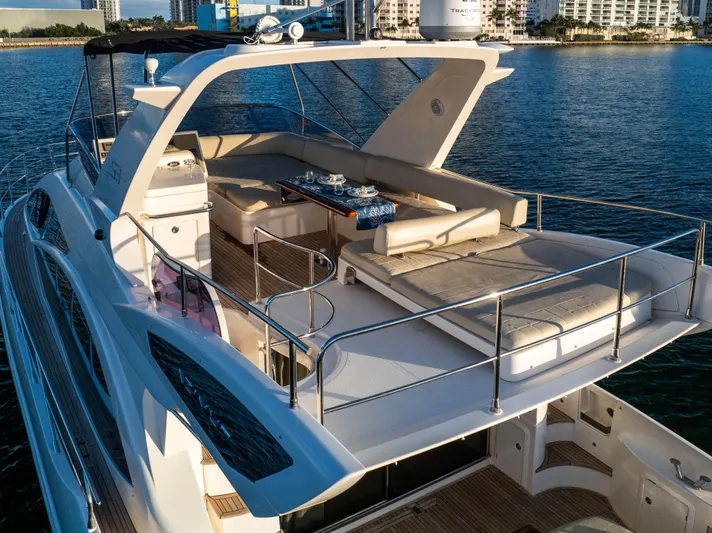 Blue Sea Yacht Photos Pics Luxurious 2012 Azimut 53 yacht with spacious deck, elegant seating, and scenic waterfront view.