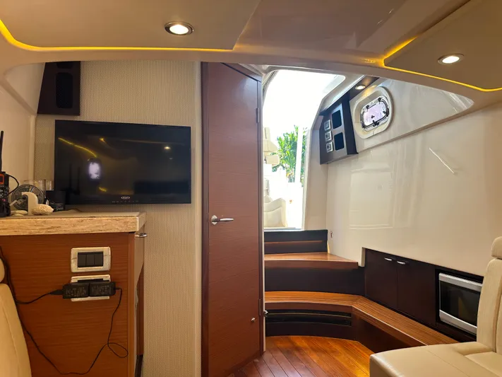 Leap Year Yacht Photos Pics Luxurious interior of 2018 Pursuit 408S boat with modern amenities and wooden accents.