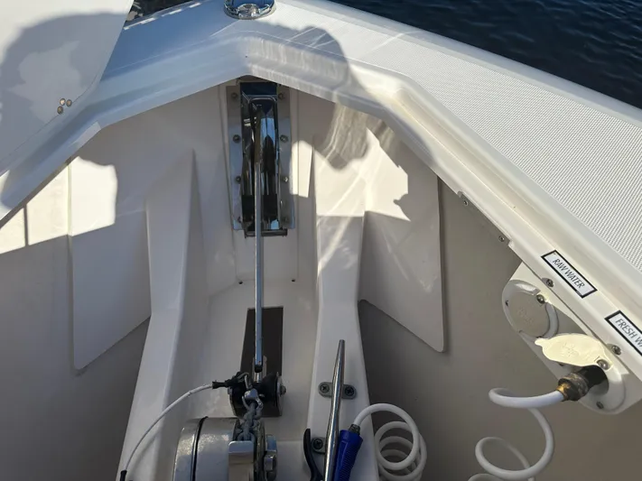Leap Year Yacht Photos Pics 2018 Pursuit 408S boat anchor compartment with winch and coiled hose.