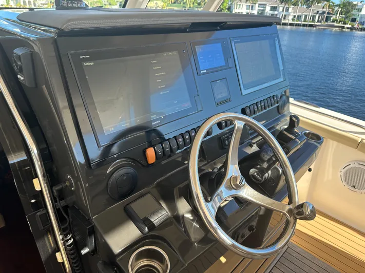Leap Year Yacht Photos Pics Helm of 2018 Pursuit 408S boat with dual navigation screens and steering wheel.