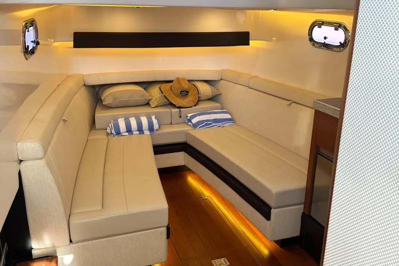 Leap Year Yacht Photos Pics Luxurious interior of 2018 Pursuit 408S boat with cozy seating and ambient lighting.