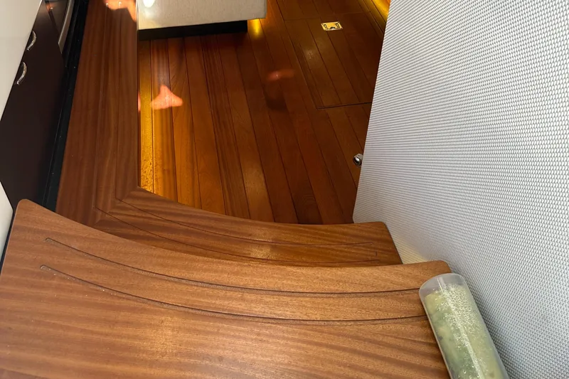 Leap Year Yacht Photos Pics Interior of a 2018 Pursuit 408S boat with wooden flooring and seating.