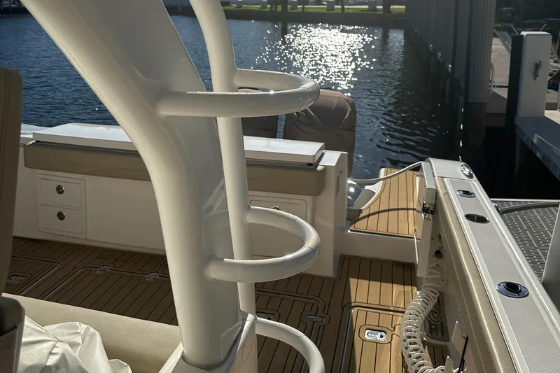 Leap Year Yacht Photos Pics 2018 Pursuit 408S boat interior with teak flooring and rod holders by the water.