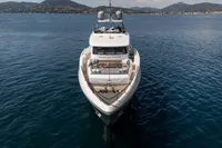 Luxury yacht Custom Line 37, 2022 model, cruising on serene waters with scenic mountain backdrop.