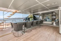 Luxurious 2022 Custom Line 37 yacht interior with elegant dining area and scenic ocean view.