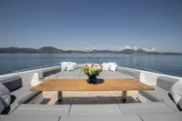 Luxurious Custom Line 37 yacht deck with seating, wooden table, and ocean view, 2022 model.