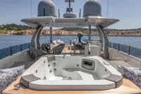 Luxurious 2022 Custom Line 37 yacht deck with jacuzzi, seating, and ocean view.