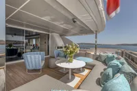 Luxurious yacht deck with elegant seating, flowers, and ocean view, Custom Line 37, 2022 model.