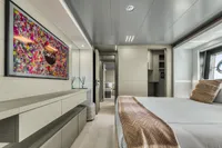 Luxurious yacht bedroom with modern decor, abstract art, and elegant furnishings, Custom Line 37, 2022.