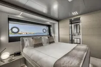Luxurious yacht bedroom with ocean view, modern decor, and elegant bedding, Custom Line 37, 2022.