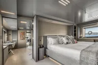 Luxurious yacht bedroom interior with modern decor, large bed, and scenic ocean view. Custom Line 37, 2022.