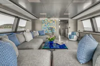 Luxurious yacht interior with modern decor, plush seating, and vibrant artwork, Custom Line 37, 2022.