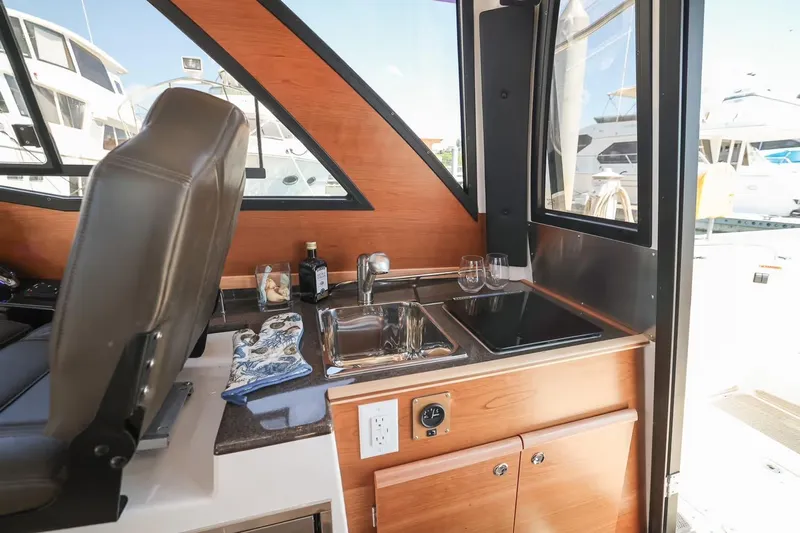  Yacht Photos Pics Interior of 2026 Cutwater C-248 Coupe featuring a compact kitchenette with sink and counter.