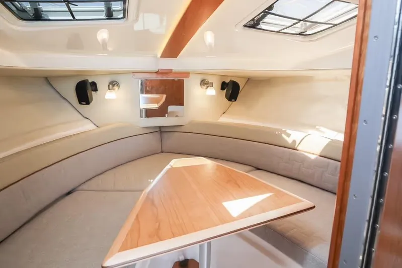  Yacht Photos Pics 2026 Cutwater C-248 Coupe interior cabin with seating and wooden table.