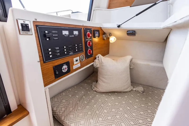  Yacht Photos Pics Cozy interior of 2026 Cutwater C-248 Coupe with control panel and cushion.