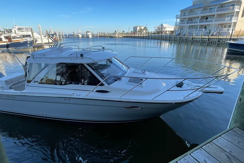  Yacht Photos Pics 2026 Cutwater C-248 Coupe boat docked in a marina, clear blue sky.