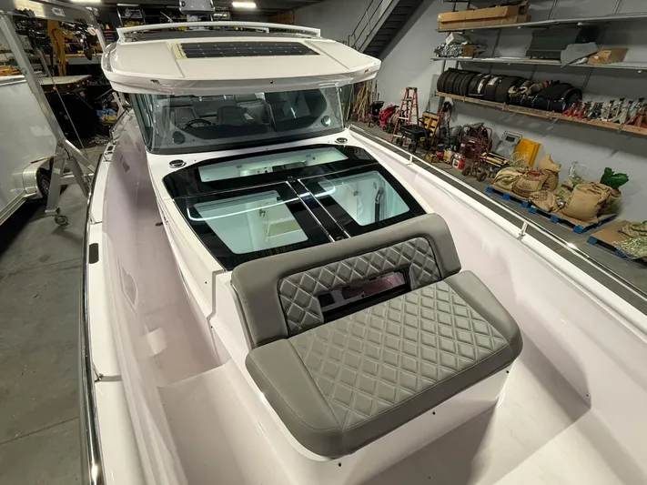  Yacht Photos Pics 2021 Axopar 37 XC CROSS CABIN boat with sleek design in a storage facility.