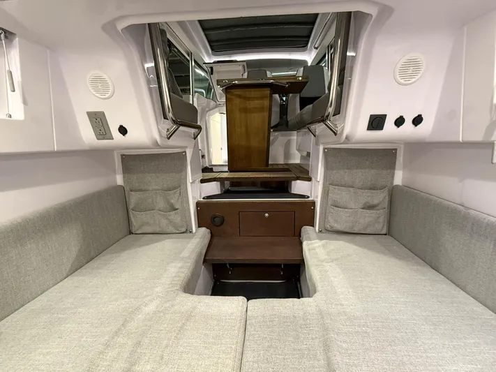 Yacht Photos Pics Interior of 2021 Axopar 37 XC CROSS CABIN with gray seating and wooden table.
