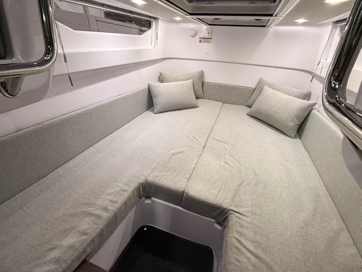  Yacht Photos Pics 2021 Axopar 37 XC CROSS CABIN interior with gray cushioned seating and pillows.