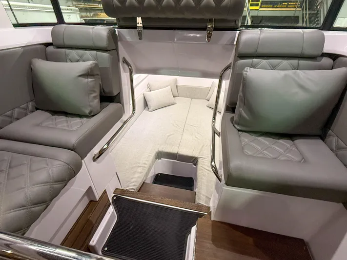  Yacht Photos Pics 2021 Axopar 37 XC CROSS CABIN interior with gray seating and cozy cabin area.