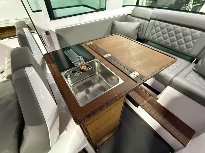  Yacht Photos Pics 2021 Axopar 37 XC CROSS CABIN interior with sink and seating area.