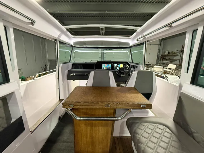  Yacht Photos Pics Interior of 2021 Axopar 37 XC CROSS CABIN with modern seating and wooden table.
