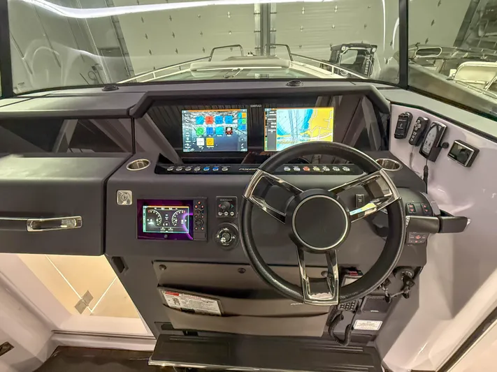 Yacht Photos Pics Cockpit of 2021 Axopar 37 XC CROSS CABIN with modern navigation displays and controls.