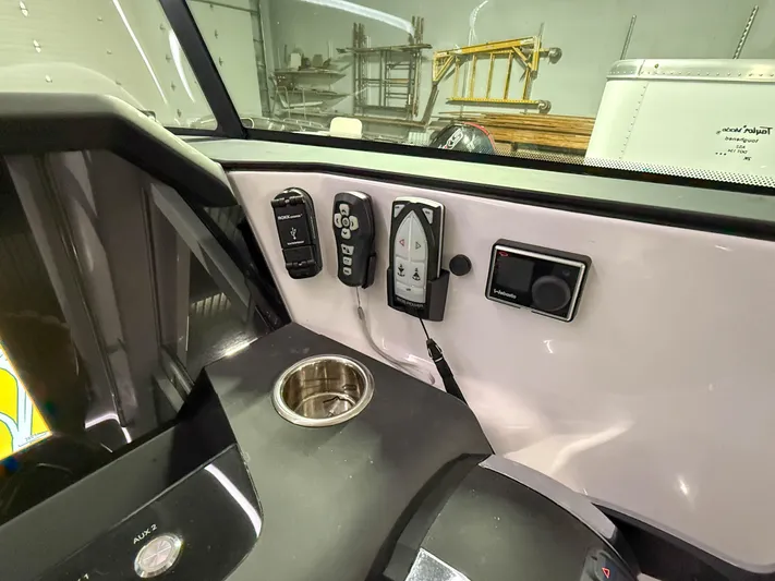  Yacht Photos Pics Control panel of 2021 Axopar 37 XC CROSS CABIN with cup holder and electronic controls.