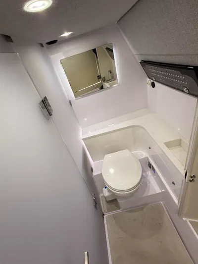  Yacht Photos Pics 2021 Axopar 37 XC CROSS CABIN bathroom with modern fixtures and sleek design.