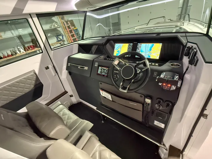  Yacht Photos Pics Interior of 2021 Axopar 37 XC CROSS CABIN with modern dashboard and navigation screens.
