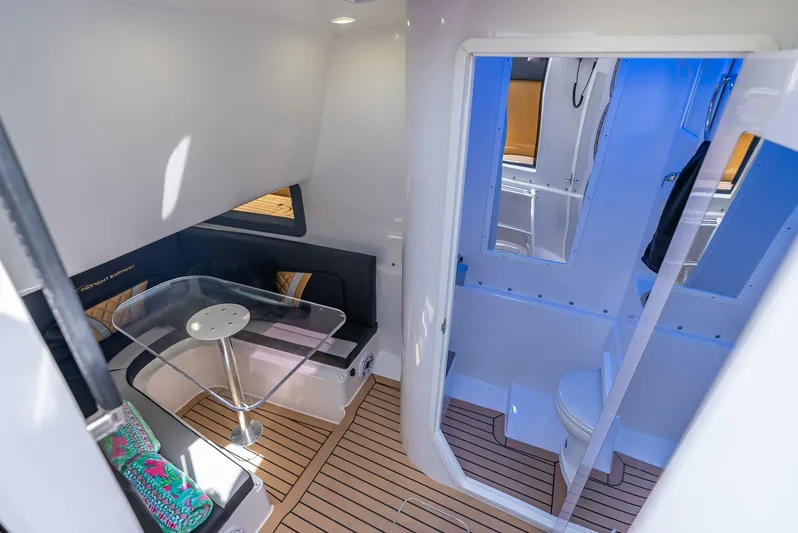 Perla Bianca II Yacht Photos Pics 2023 Midnight Express 43 Open interior with seating, table, and bathroom.