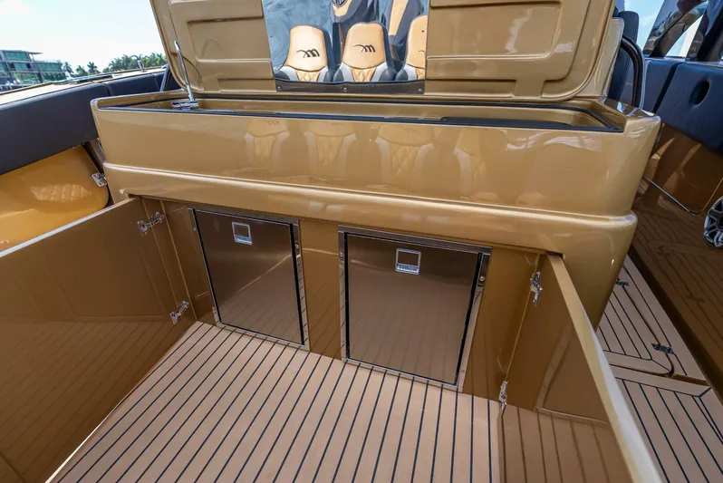 Perla Bianca II Yacht Photos Pics 2023 Midnight Express 43 Open boat interior with storage compartments and sleek design.